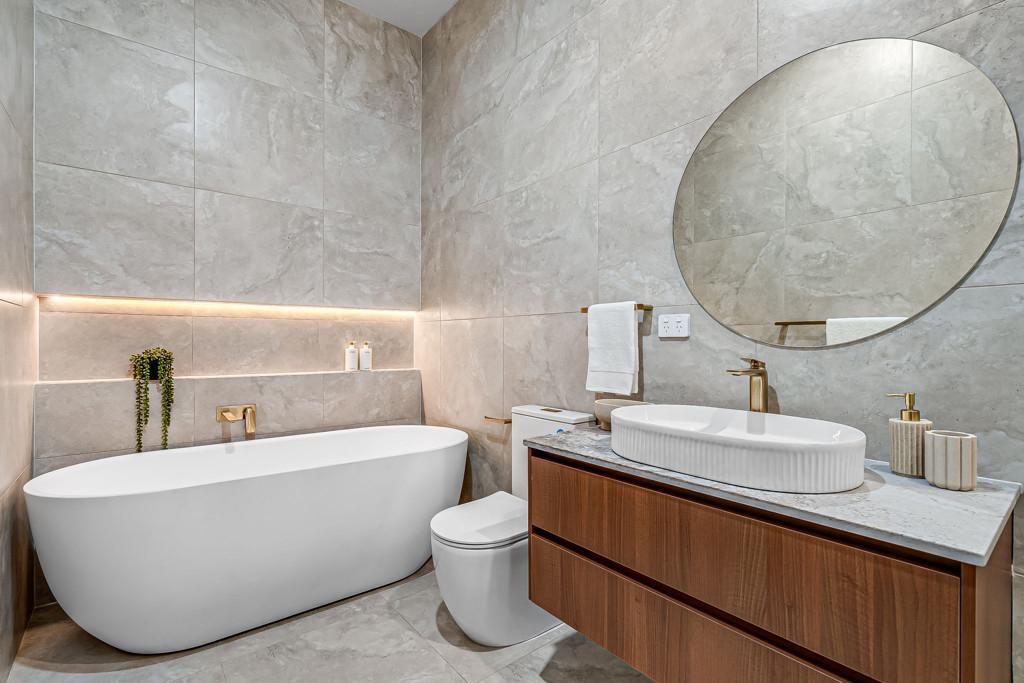 Wall-hung timber bathroom vanity with stone top