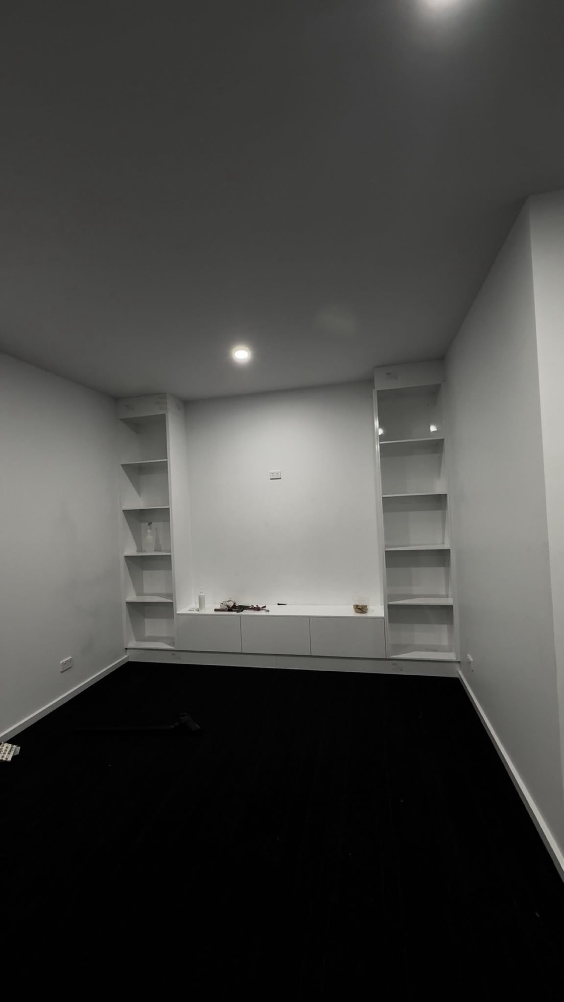 Built-in white shelving and storage unit