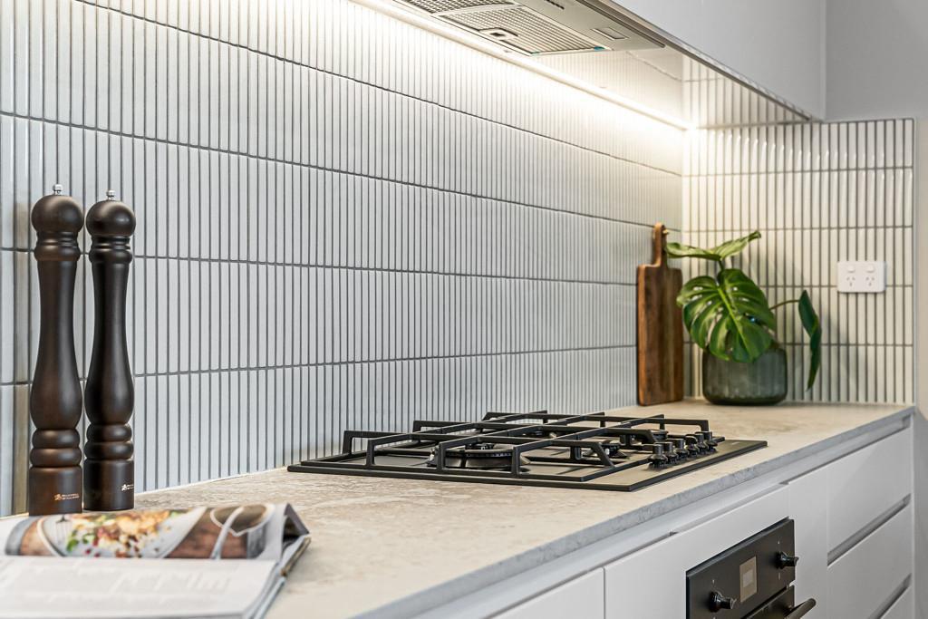 Kitchen benchtop with cooktop and tiled splashback